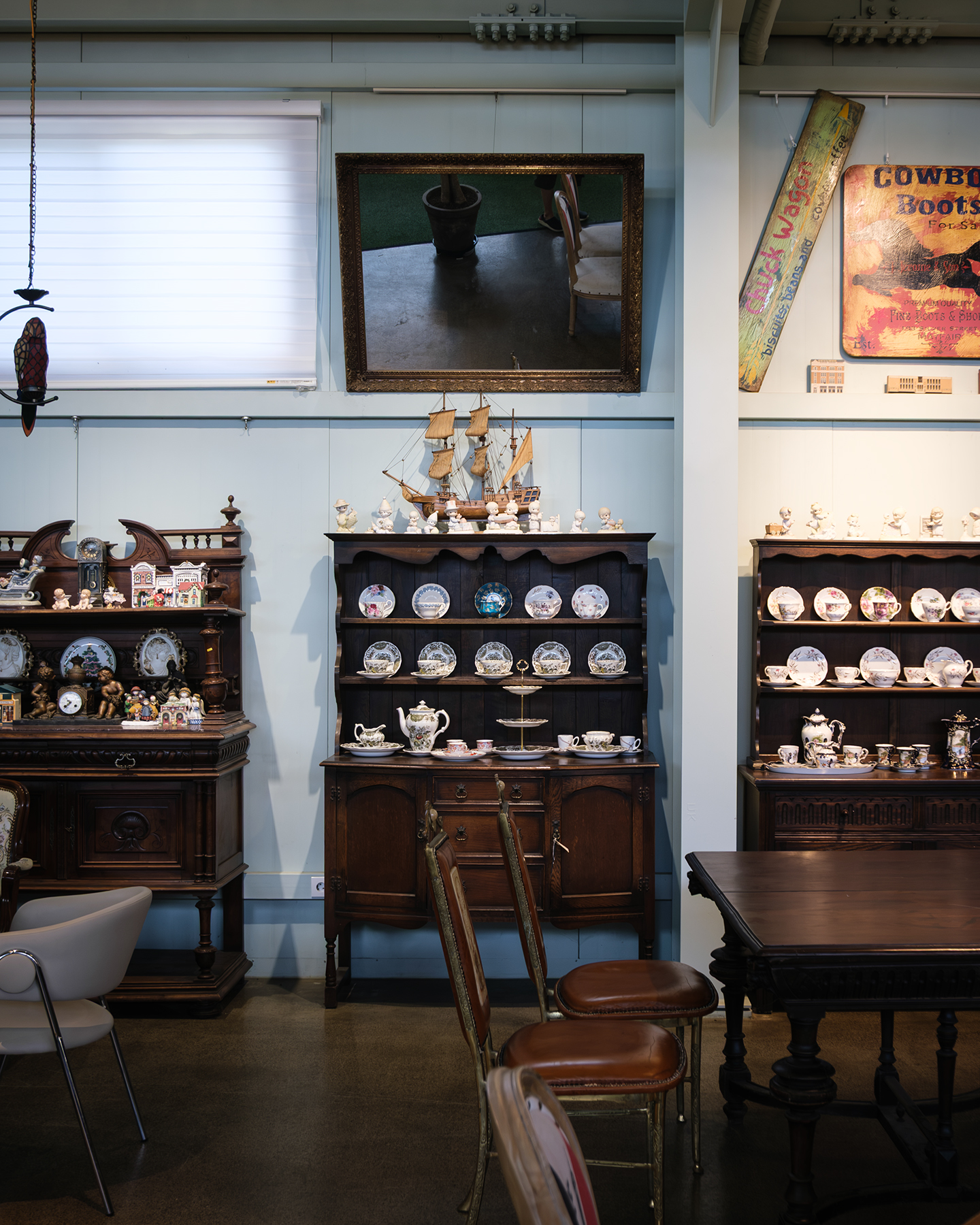 Ceramics - Antique wooden cabinets display ceramic plates and teacups beneath a mirror in a softly lit vintage interior. - #Cafe #Ceramics #Table #HouseYongam #SouthKorea