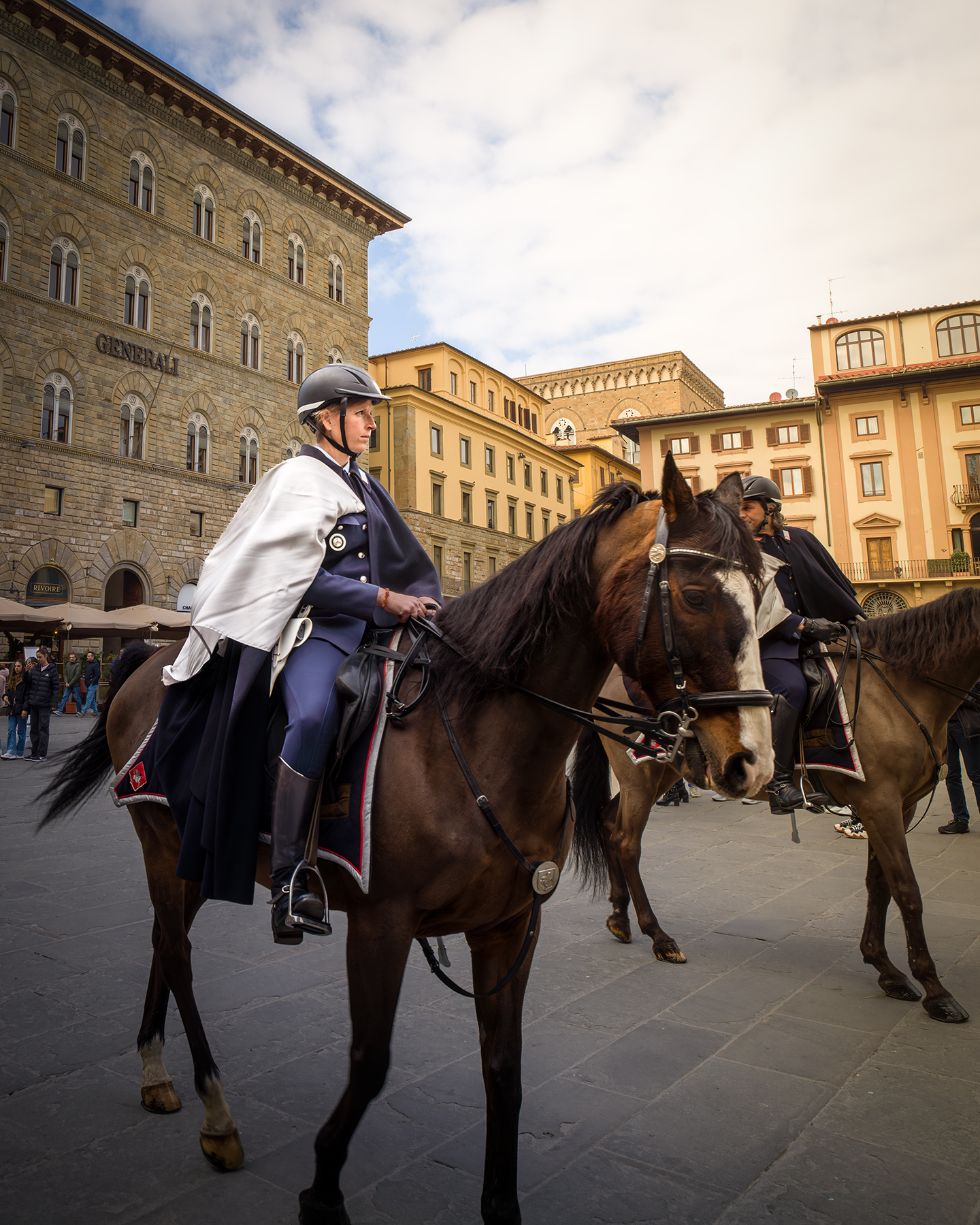 Florence - Uniformed riders on horseback move through a stone-paved square framed by historic buildings under soft cloudy light. - #FlorenceFestival #FestivalInFlorence #FlorenceItaly #Firenze #FirenzeFestival #FlorenceEvents #ItalianFestival #ItalyFestival #FestivalVibes #StreetFestival