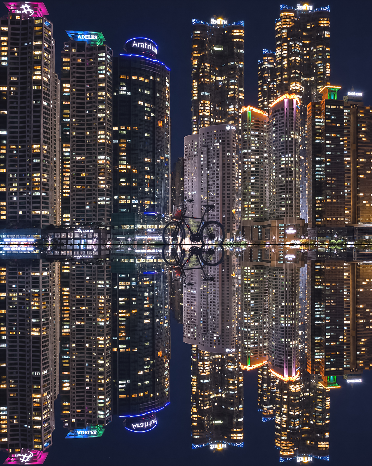 Marine City - A silhouetted bicycle stands before illuminated high-rises at night, mirrored in still water with colorful neon accents. - #Busan #Haeundae #MarineCity #BusanNightView #BusanNightscape #BusanSkyline #BusanCityscape #HaeundaeNightView #MarineCityNight #DoosanWeveTheZenith