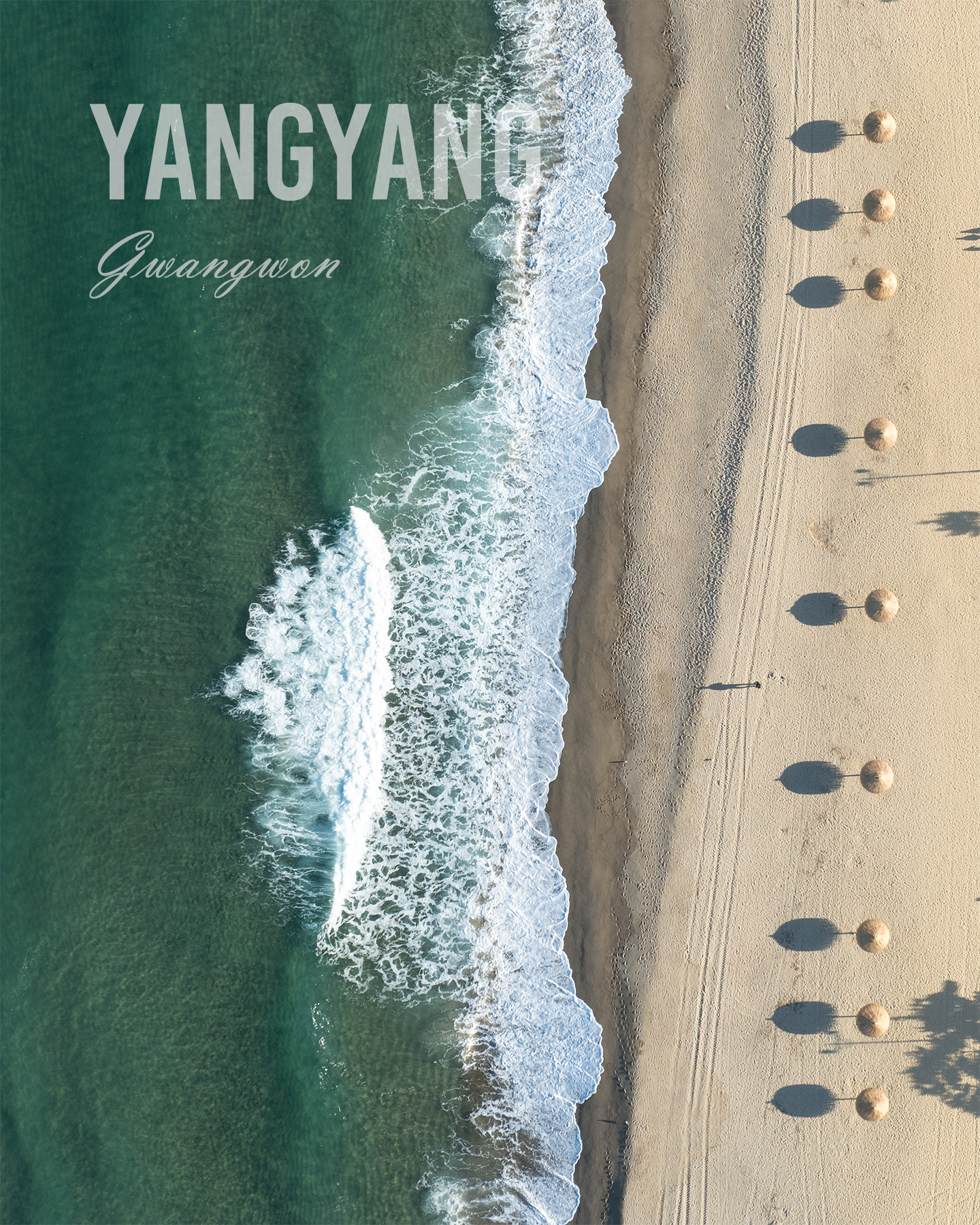 Yangyang - An aerial view shows emerald waves washing onto a sandy beach lined with parasols and long shadows. - #Beach #Ocean #Sea #Waves #OceanWaves #SeaWaves #SandyBeach #EmeraldSea #TurquoiseWater #Coastline