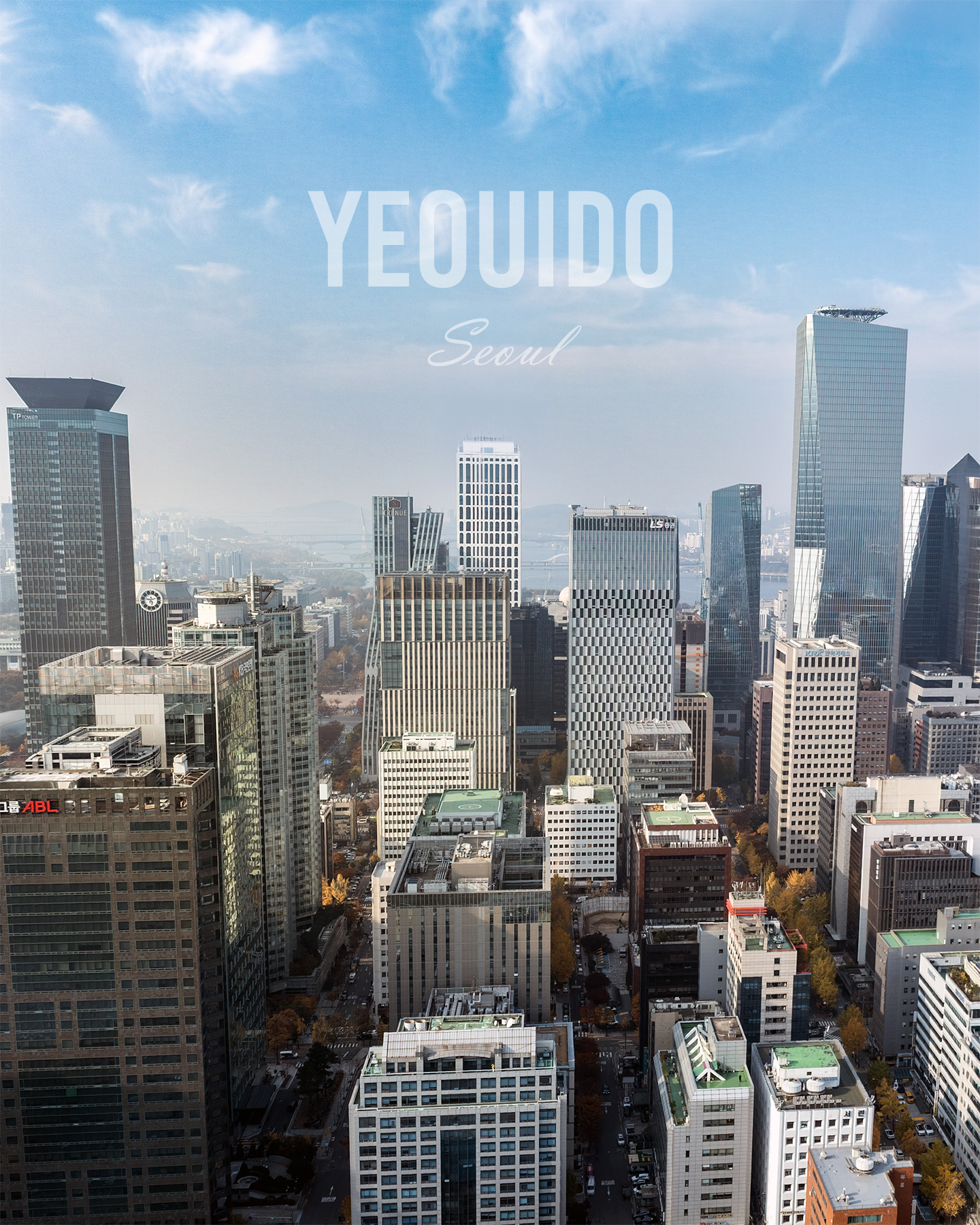 Yeouido - A hazy urban skyline of high-rise office towers rises beneath a blue sky with wispy clouds and soft daylight. - #Yeouido #YeouidoSeoul #YeouidoSkyline #Seoul #SeoulKorea #SeoulSkyline #SeoulCityscape #SeoulView #HanRiver #HanRiverView