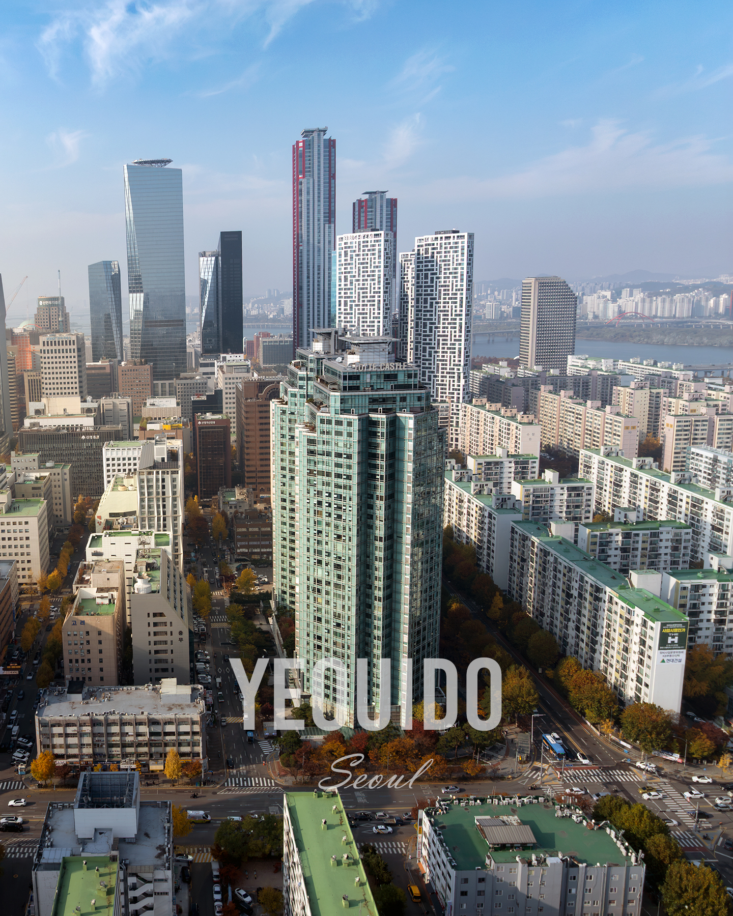 Yeouido - A high-angle cityscape shows dense high-rises, apartment blocks, roads, and a river under a clear blue sky. - #Yeouido #YeouidoSeoul #YeouidoSkyline #Seoul #SeoulKorea #SeoulSkyline #SeoulCityscape #SeoulView #HanRiver #HanRiverView