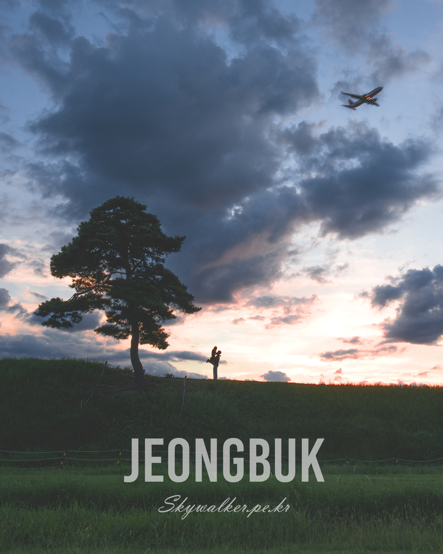 Jeongbuk Fortress - A silhouetted tree and two figures stand on a grassy ridge under dramatic sunset clouds as an airplane crosses the sky. - #sunset #silhouette #tree #airplane #clouds #sky #grassland #landscape #twilight #dramaticlight