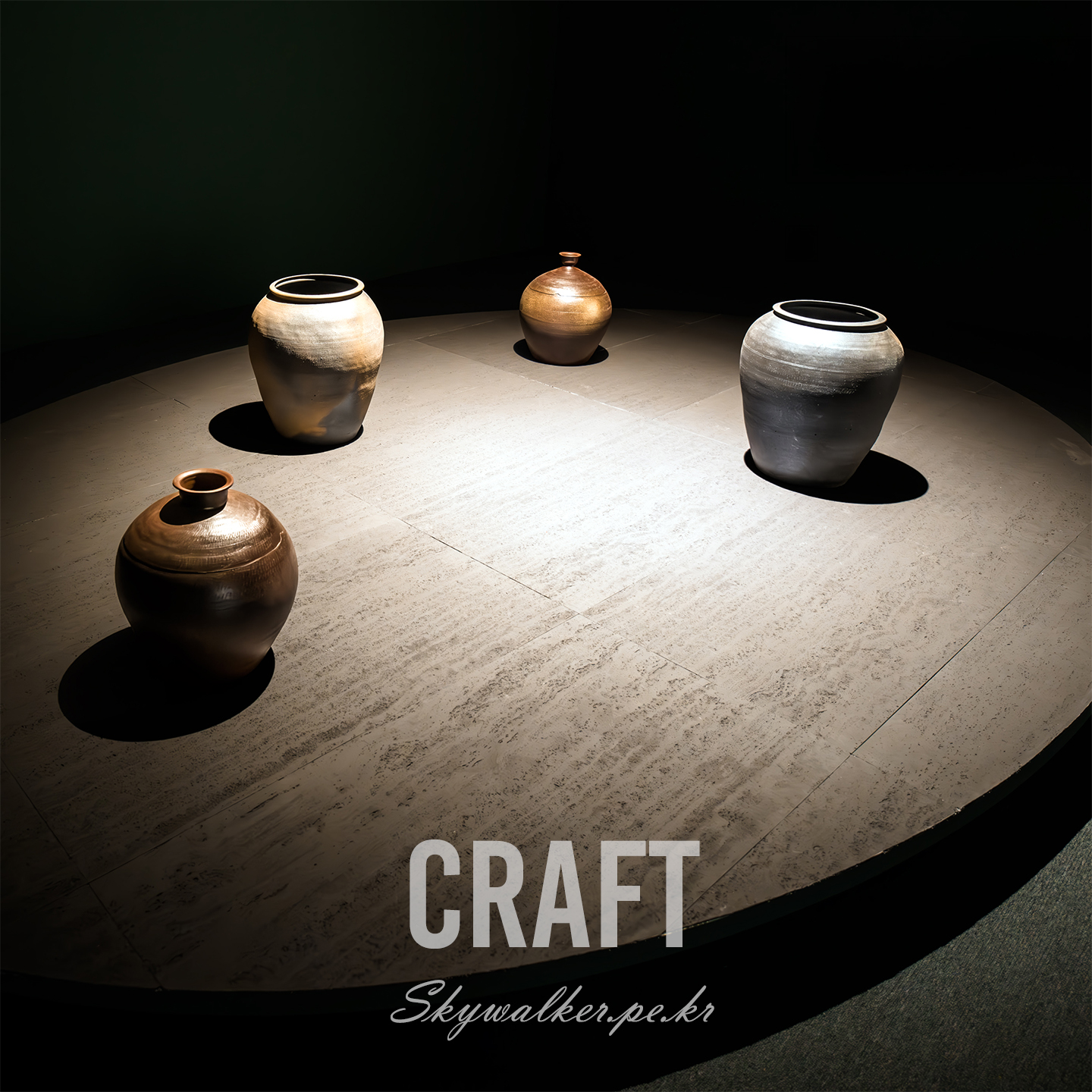Craft - Four ceramic vessels sit on a circular display under dramatic spotlights in a dark room. - #Ceramics #Pottery #Craft #Vessels #Spotlight #StillLife #Exhibition #ClayArt #Minimalism #Shadows