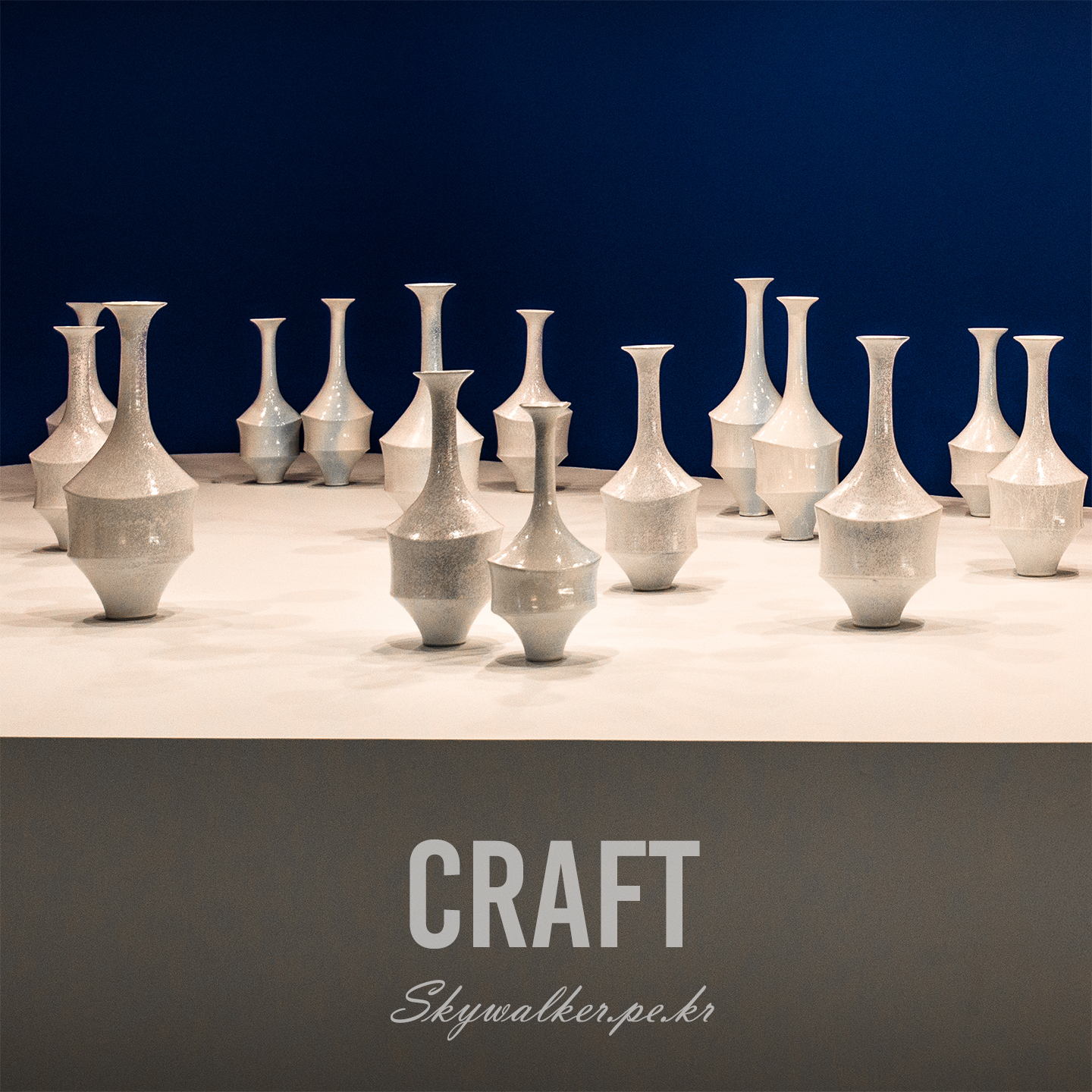 Craft - Glossy ceramic vases stand on a white display against a deep blue backdrop under soft gallery lighting. - #Craft #Ceramics #Vases #Pottery #StillLife #ArtDisplay #BlueBackdrop #Minimalism #Glossy #Composition